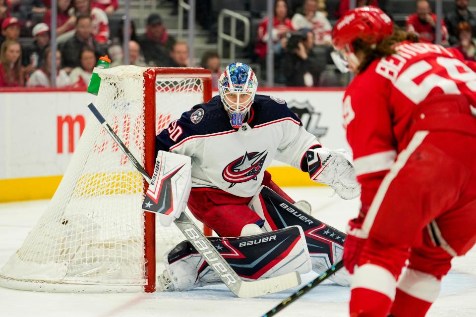 Columbus Blue Jackets goaltender Elvis Merzlikins (90) keeps his eyes on the puck as Detroit Red Wings left wing Tyler Bertuzzi (59) skates to the net during the second period at Little Caesars Arena.