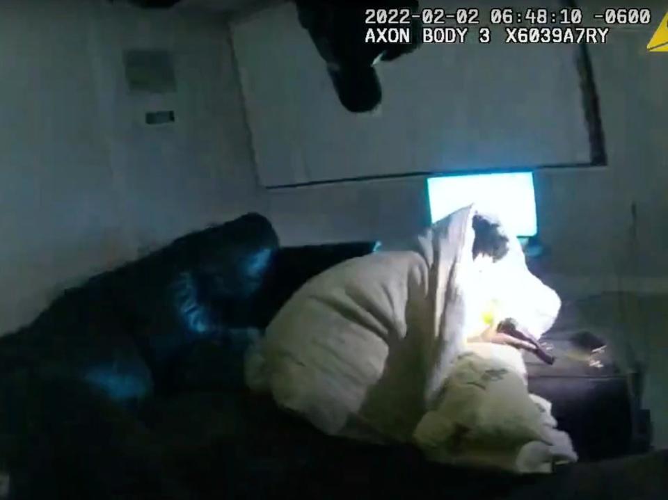 Body camera video shows 22-year-old Amir Locke wrapped in a blanket on a couch holding a gun moments before he was shot by Minneapolis police on Wednesday, Feb 2, 2022 (AP)