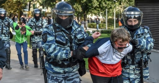 Russian National Guard officers detain protesters following a rally calling for fair elections in Moscow