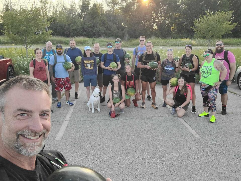 Members of the Good Land Ruck Club in Milwaukee pose with their watermelons during the "watermelon ruck." For this activity, each member had to carry a whole watermelon at least three miles, said group leader Danny Clayton Veseth.