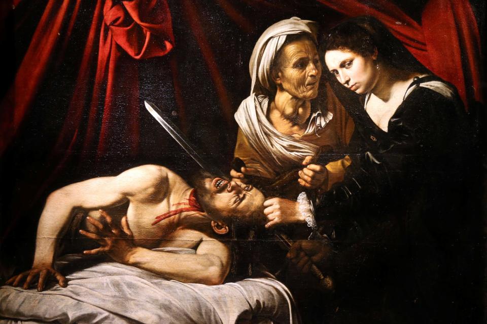 The painting entitled "Judith Beheading Holofernes" pictured during its presentation in Paris, attributed to the Italian master Caravaggio