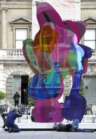 Photographers take photographs of 'Coloring Book', a sculpture by Jeff Koons, in the Annenberg Courtyard of the Royal Academy of Arts, in London May 17, 2011. REUTERS/Paul Hackett