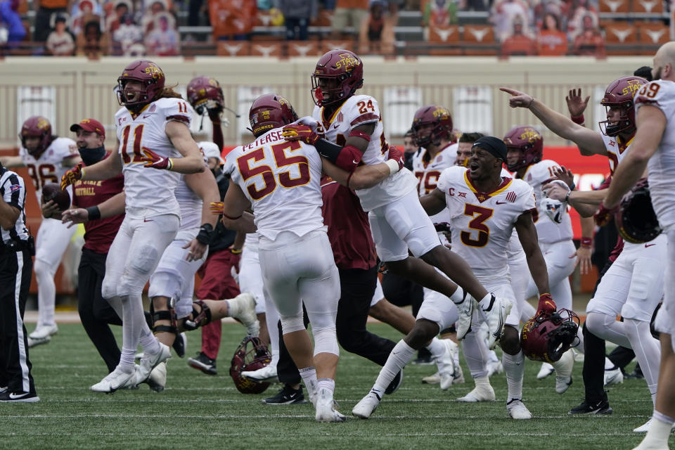 Iowa State players and coaches storm the field as they celebrate their win over Texas in an NCAA college football game, Friday, Nov. 27, 2020, in Austin, Texas. (AP Photo/Eric Gay)