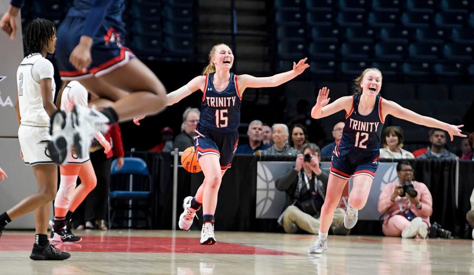 Trinity's Maddie Smith (15) and Trinity's Emma Kate Smith (12) celebrate defeating Clements in the AHSAA 3A girls state basketball championship game at Legacy Arena in Birmingham, Ala., on Friday March 3, 2023. 