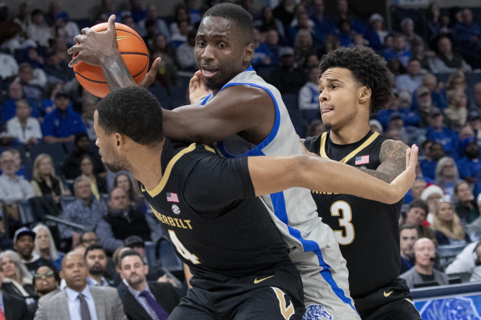 Memphis forward David Jones, center, gets caught between the defense of Vanderbilt guard Isaiah West (4) and guard Paul Lewis (3) during the first half of an NCAA college basketball game Saturday, Dec. 23, 2023, in Memphis, Tenn. (AP Photo/Nikki Boertman)