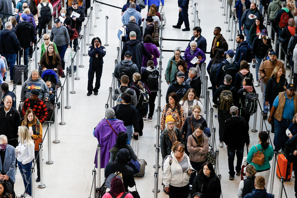 Image: A TSA agent directs passengers   on Nov. 21, 2022, in Kenner, La.  (Aaron M. Sprecher / AP)