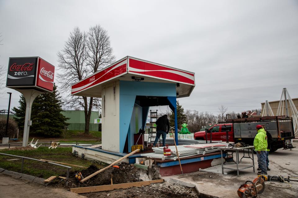 Workers rebuild the Coke Cafe at Adventureland in Altoona, Friday, April 15, 2022.