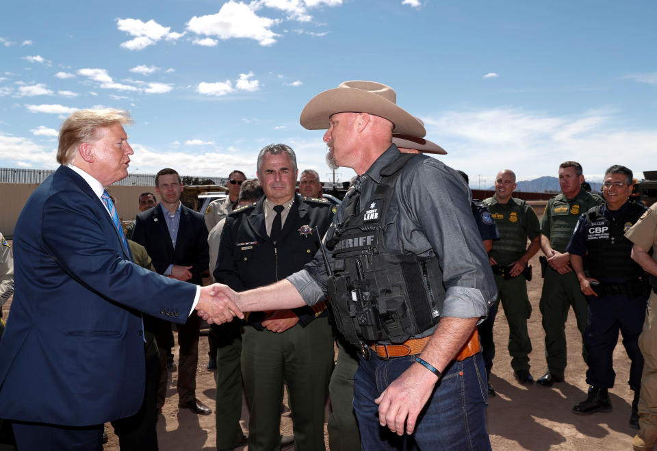 Then-President Donald Trump greets Sheriff Mark Lamb of Pinal County, Ariz., as he meets with U.S. Border Patrol agents and local law enforcement officers and sheriffs while visiting the U.S.-Mexico border in Calexico, Calif., in 2019.