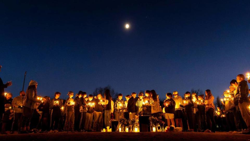 Friends and family gather on the Hillside Junior High baseball diamond for a candlelight vigil remembering the life of Kade Parrish.