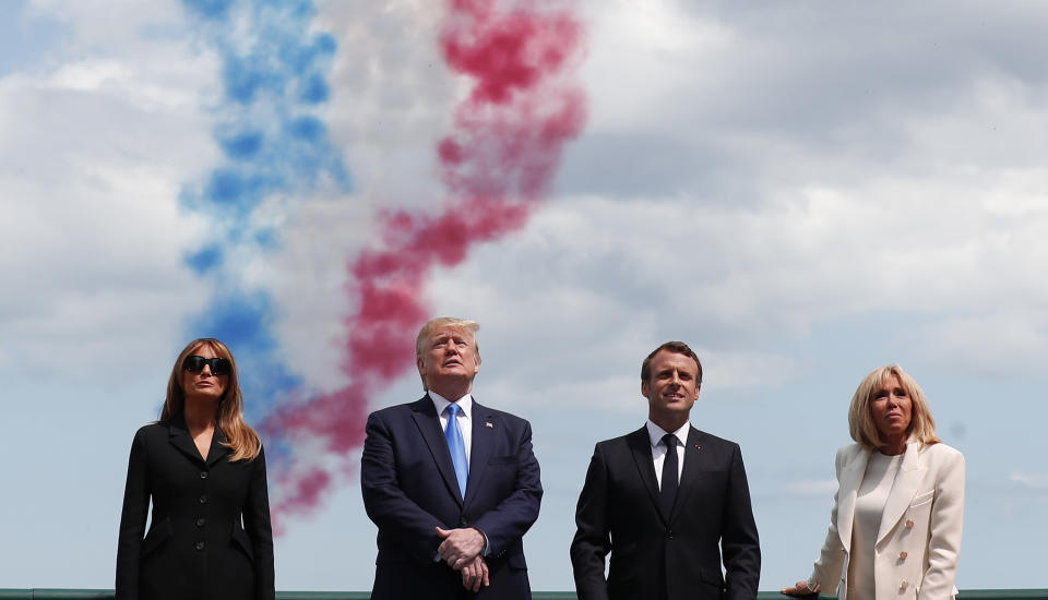 U.S President Donald Trump, U.S First Lady Melania Trump, left, French President Emmanuel Macron, second right, and his wife Brigitte Macron, right, attend a ceremony to mark the 75th anniversary of D-Day at the Normandy American Cemetery in Colleville-sur-Mer, Normandy, France, Thursday, June 6, 2019. World leaders are gathered Thursday in France to mark the 75th anniversary of the D-Day landings. (Ian Langsdon/POOL via AP)