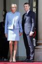 <p>Wearing a light blue skirt suit and nude heels with her husband on the on the steps of the Elysee Palace in Paris, France.</p>