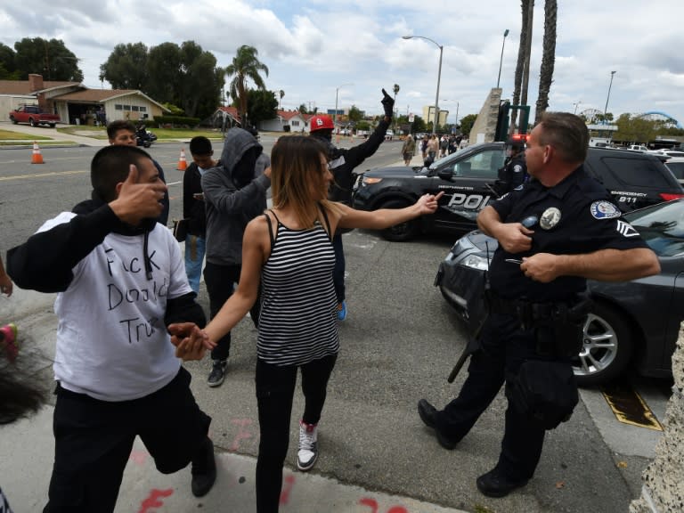 Anti-Trump protesters gesture at police outside the Anaheim Convention Center after a rally for Republican presidential candidate Donald Trump in Anaheim, California