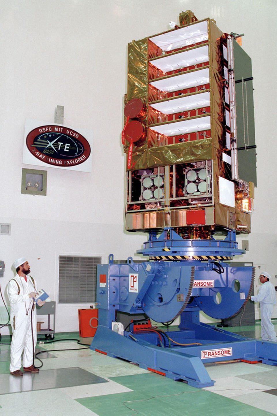 NASA's Rossi X-ray Timing Explorer satellite, shown here during prelaunch checks in 1995, was built to study the time variation of X-ray sources in space. <cite>NASA</cite>