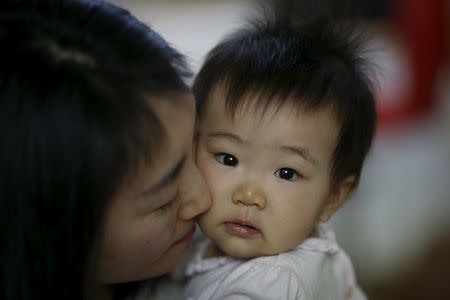 Jeong Bo-mi, 37, among a group of South Korean parents who sued a post-partum care centre seeking compensation after babies were infected with latent tuberculosis, takes care of her baby, who was not infected but was treated as a preventive measure, at her home in Seoul, South Korea, April 7, 2016. REUTERS/Kim Hong-Ji