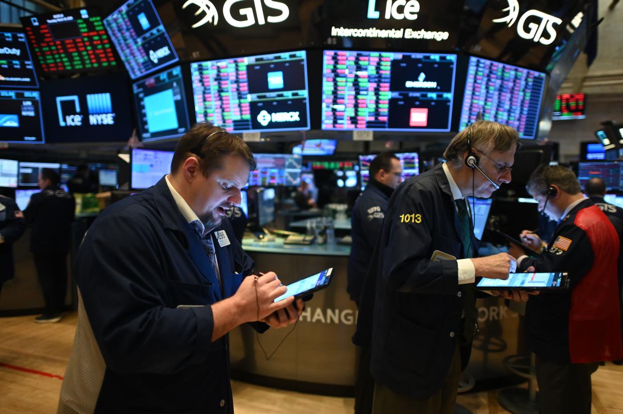 Traders work during the opening bell at the New York Stock Exchange (NYSE) on March 19, 2020, at Wall Street in New York City. - Wall Street stocks fell again early Thursday as central banks unveiled new stimulus measures and US jobless claims showed an initial hit from the slowdown generated by the coronavirus outbreak. (Photo by Johannes EISELE / AFP) (Photo by JOHANNES EISELE/AFP via Getty Images)