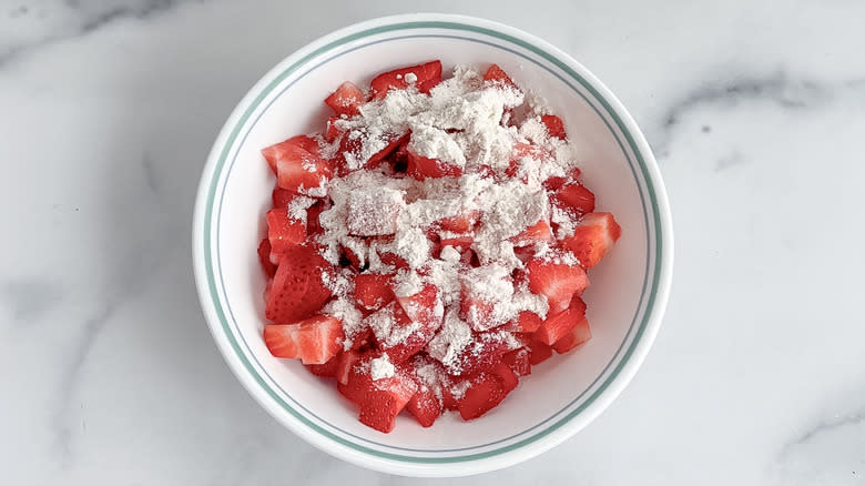 chopped strawberries coated with flour in bowl