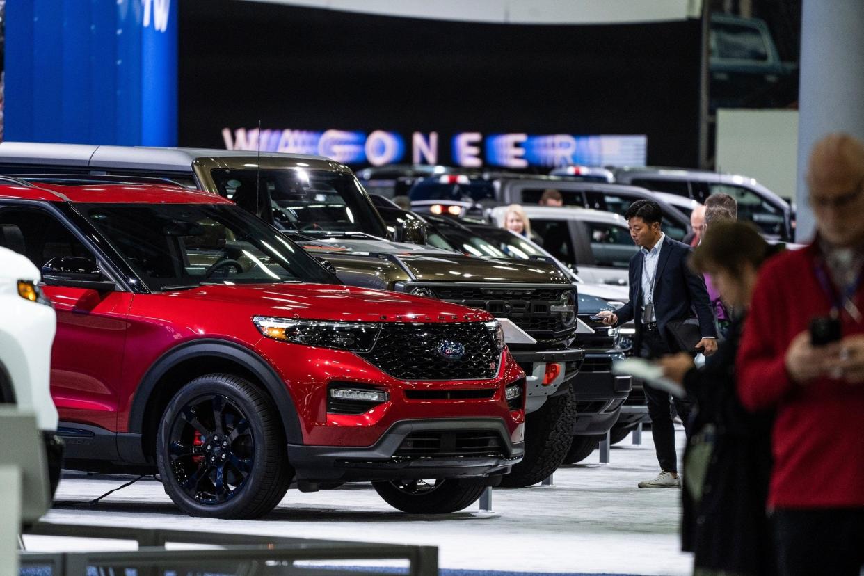 People look over the Ford Motor Co. lineup on display during the 2023 North American International Detroit Auto Show held at Huntington Place in downtown Detroit on Sept. 13, 2023.