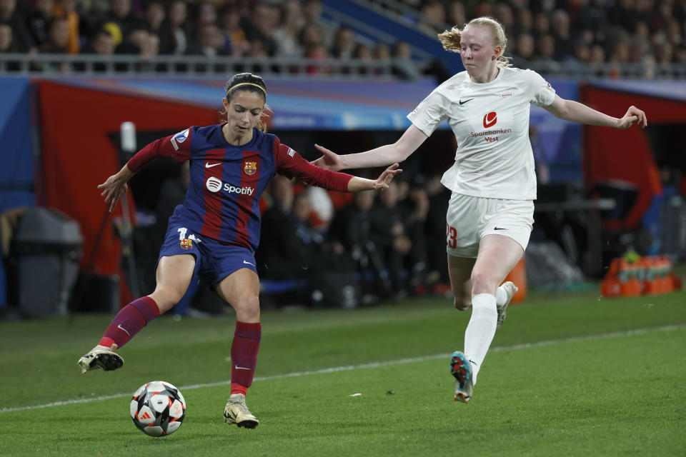 Barcelona's Aitana Bonmati, left, challenges for the ball with Brann's Tomine Svendheim during the women's Champions League quarterfinals, second leg, soccer match between FC Barcelona and SK Brann Kvinner at the Estadi Johan Cruyff in Barcelona, Spain, Thursday, March 28, 2024. (AP Photo/Joan Monfort)