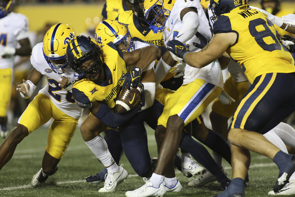 West Virginia's Beanie Bishop Jr. (11) is tackled by Pittsburgh's defense during the first half of an NCAA college football game, Saturday, Sept. 16, 2023, in Morgantown, W.Va. (AP Photo/Chris Jackson)