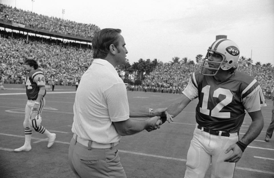FILE- Miami Dolphins head coach Don Shula greets New York Jets quarterback Joe Namath (12) at the end of their game at the Orange Bowl on Nov. 19, 1972, in Miami. Fifty years ago, the Miami Dolphins defeated the then-Washington Redskins in the Super Bowl to complete their perfect 17-0 season. Even though they weren't chasing perfection at the time, they ended up accomplishing something that no team since has repeated. (AP Photo, File)