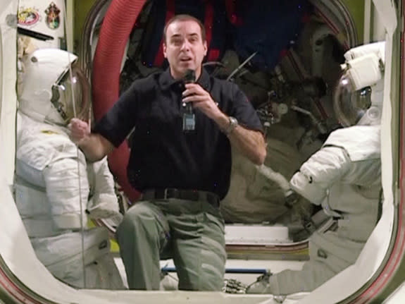 NASA astronaut Rick Mastracchio speaks with Space.com from the International Space Station while flanked by two U.S. spacesuits. Image uploaded Jan. 31, 2014.