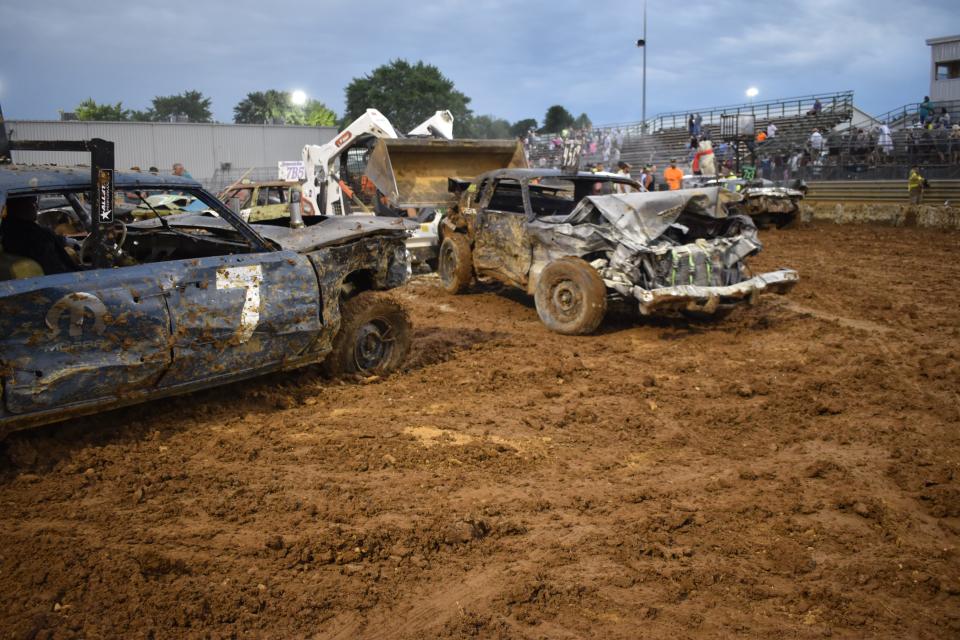 The cars of brothers Matt and Aaron Crane at the end of the main event at the 2022 Monroe County Fair Demolition Derby.