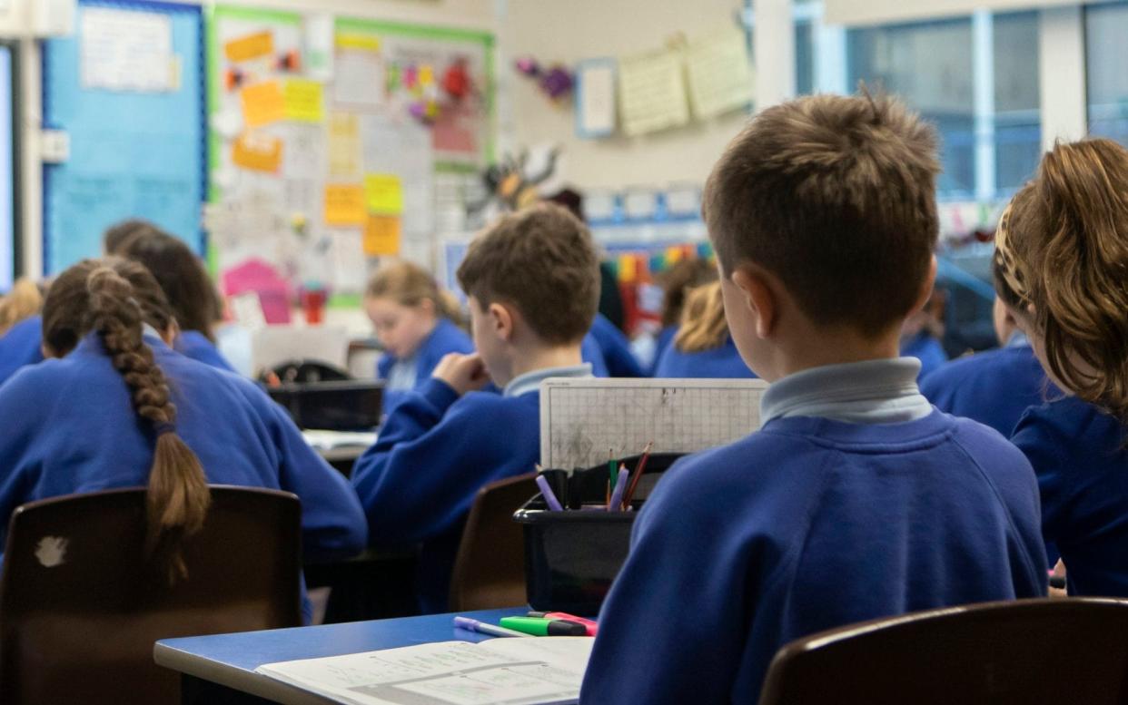 File photo dated 27/11/19 of school children during a Year 5 class at a primary school. Schools may feel like a "strange place" to pupils when they return next month due to safety measures amid the coronavirus pandemic, a leading psychiatrist has warned. PA Photo. Issue date: Monday July 20, 2020. Many children will be looking forward to being reunited with their friends and returning to formal learning next month for the first time since March, but classes will not be the same as they were before lockdown.  - Danny Lawson/PA Wire