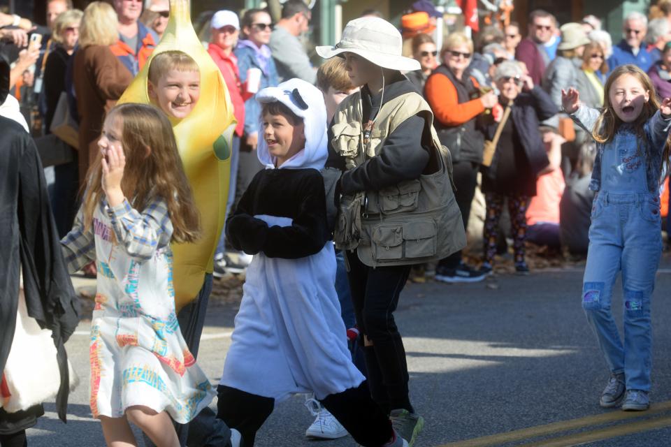 Students walk down Main Street in Harbor Springs during the 2022 Halloween Parade.