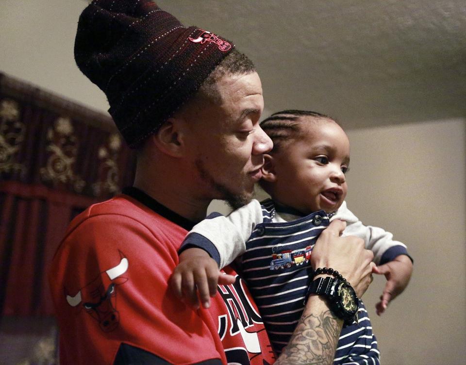 Kevyn Burston Sr., spends time with his then-13-month-old son Kevyn "KJ" Burston on March 1, 2017. The Columbus Urban League works to debunk long-held, negative stereotypes about Black fathers and their involvement in their children's lives.
