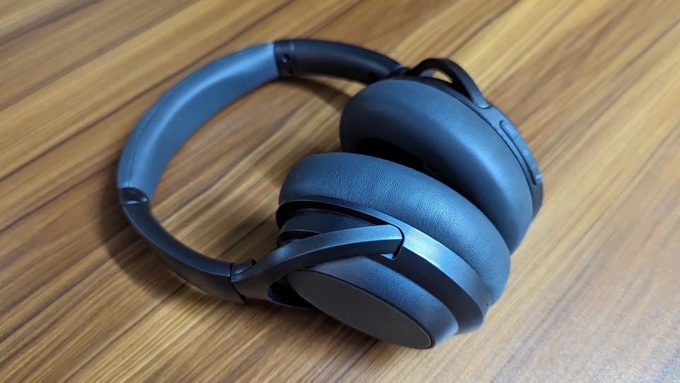 Treblab Z7 Pro wireless headphones on a wooden table.