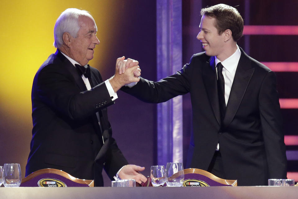 FILE - Team owner Roger Penske, left, greets Brad Keselowski at the start of the season-ending NASCAR awards ceremony, Friday, Nov. 30, 2012, in Las Vegas. Keselowski won the Sprint Cup title in 2012. Heading into the race Sunday, Oct. 31, 2021, at Martinsville Speedway, Keselowski is in the final two races of his NASCAR career with Team Penske and would love nothing more than to close his 12-year run with another Cup championship. (AP Photo/Julie Jacobson, File)