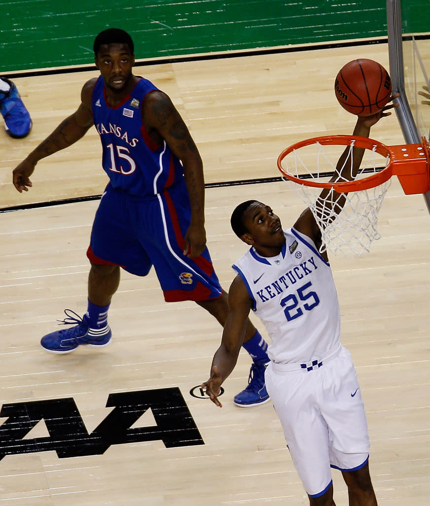 Marquis Teague #25 of the Kentucky Wildcats lays the ball up against Elijah Johnson #15 of the Kansas Jayhawks in the first half in the National Championship Game of the 2012 NCAA Division I Men's Basketball Tournament at the Mercedes-Benz Superdome on April 2, 2012 in New Orleans, Louisiana. (Photo by Chris Graythen/Getty Images)