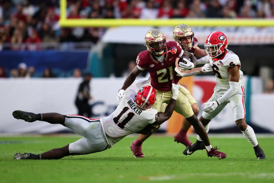 Florida State Seminoles wide receiver Darion Williamson (21) runs with the ball against Georgia Bulldogs linebacker Jalon Walker (11) during the first half December 30, 2023, in the 2023 Orange Bowl at Hard Rock Stadium in Miami Gardens, Florida.