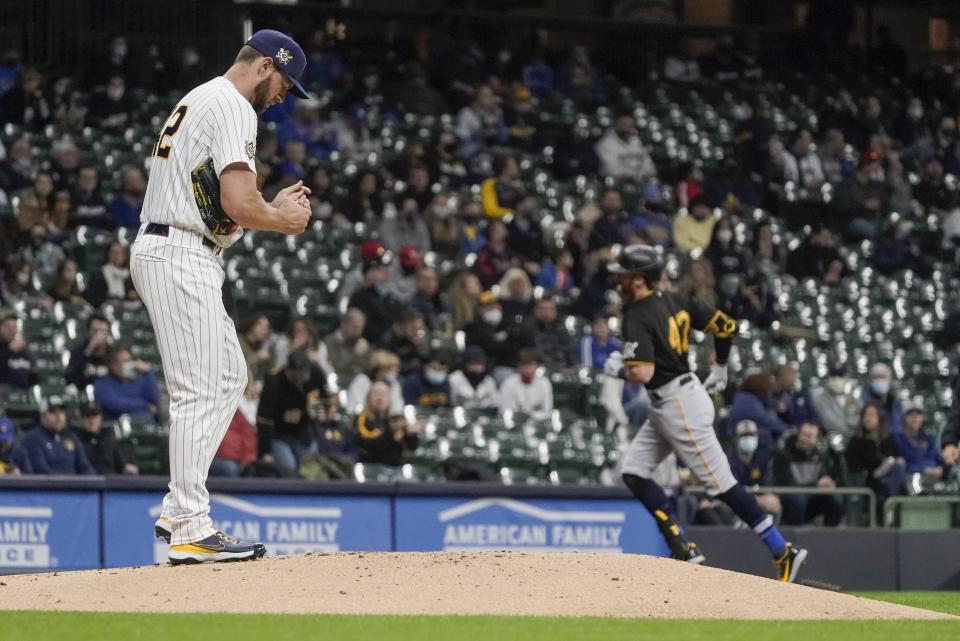 Milwaukee Brewers starting pitcher Adrian Houser reacts after giving up a home run to Pittsburgh Pirates' Colin Moran during the second inning of a baseball game Friday, April 16, 2021, in Milwaukee. (AP Photo/Morry Gash)