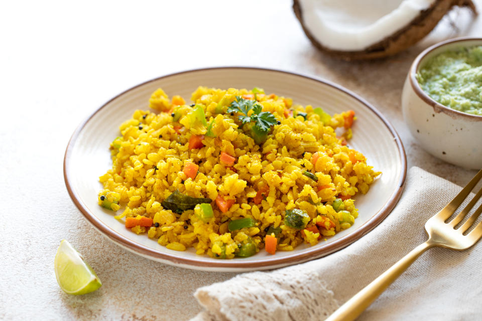 Indian cuisine Indian food. Indian cuisine. Poha or flattened rice traditional Western Indian breakfast with coconut chutney sauce curry leaves. national authentic vegetarian Asian food