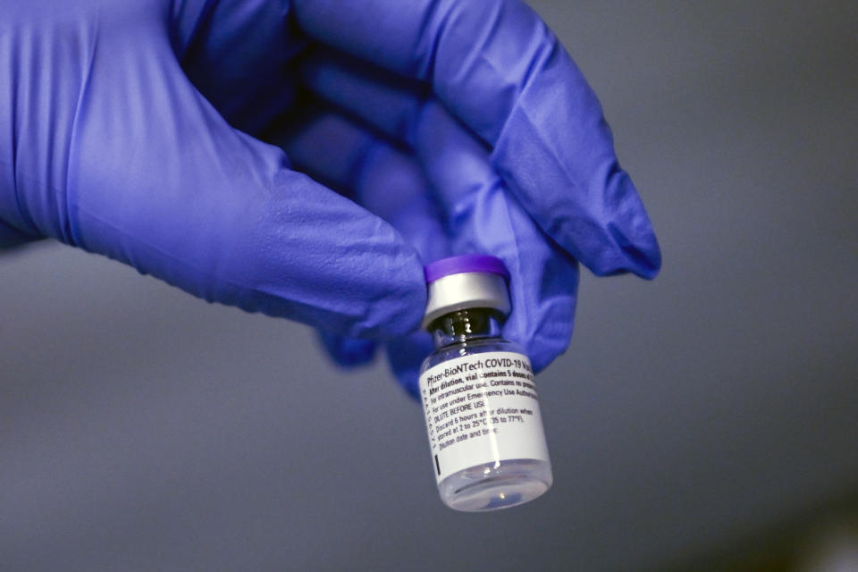 A medical staff member holds a vial of Pfizer-BioNTech COVID-19 vaccine, at the Amedeo di Savoia Hospital, in Turin, Italy, Sunday, Dec. 27, 2020. European Union nations officially kicked off a coordinated effort Sunday to give COVID-19 vaccinations to some of the most vulnerable among their nearly 450 million people, marking a moment of hope in the continent’s battle against the worst public health crisis in a century. (Marco Alpozzi/LaPresse via AP)