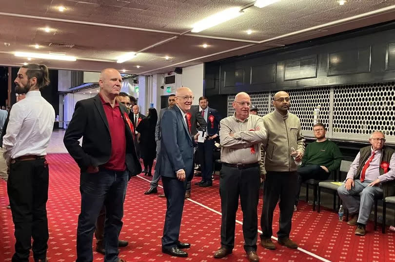 A small crowd wearing Labour rosettes watch the live election coverage inside the Queen Elizabeth Hall.