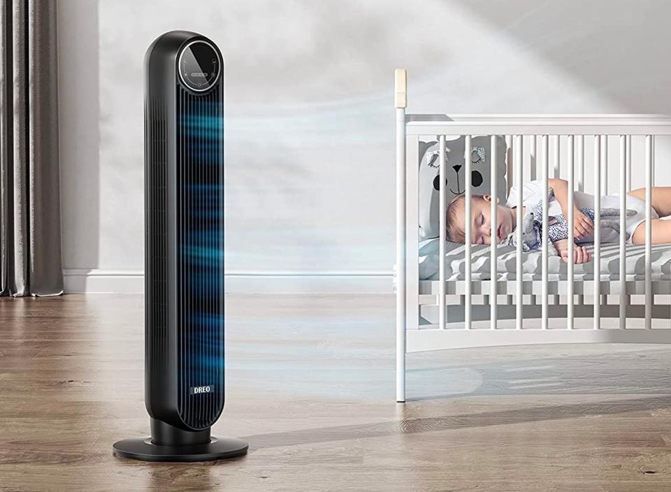 A silent tower fan cools a bedroom.