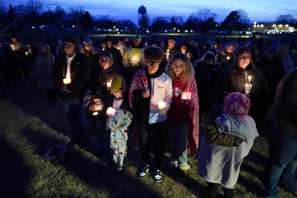 Local residents pray during a candlelight vigil following a shooting at Perry High School, Thursday, Jan. 4, 2024, in Perry, Iowa. (AP Photo/Charlie Neibergall)