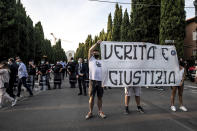 A group of angry citizen protest during a ceremony to honor coronavirus victims with a Requiem concert performed in front of the cemetery in Bergamo, Northern Italy, one of the hardest-hit provinces in the onetime epicenter of the European outbreak, Sunday, June 28, 2020. The banner reads "Truth and Justice". (Claudio Furlan/LaPresse via AP)