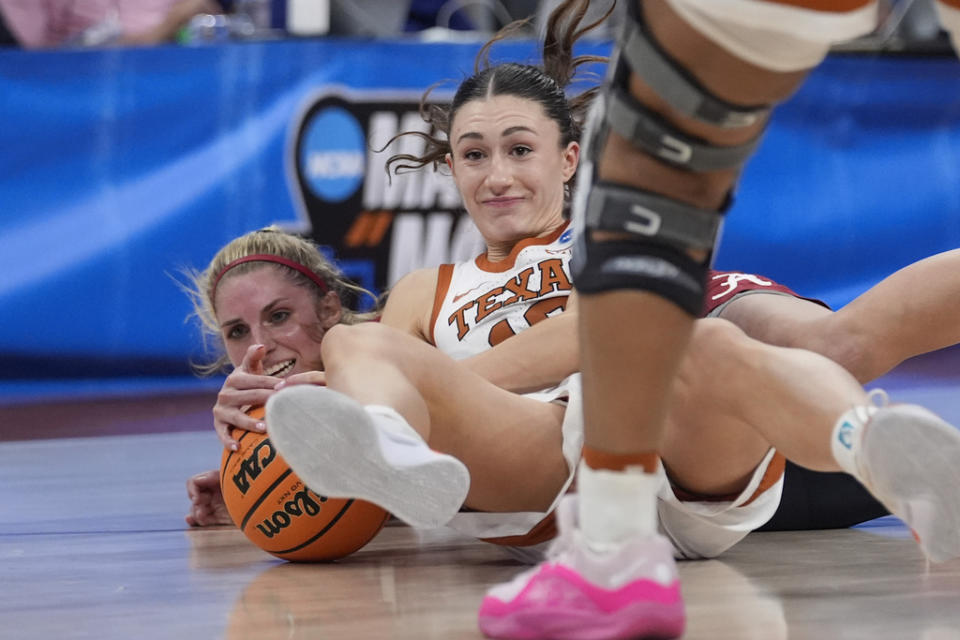 Alabama guard Sarah Ashlee Barker, left, and Texas guard Shay Holle, right, scramble for a loose ball during the second half of a second-round college basketball game in the women’s NCAA Tournament in Austin, Texas, Sunday, March 24, 2024. (AP Photo/Eric Gay)