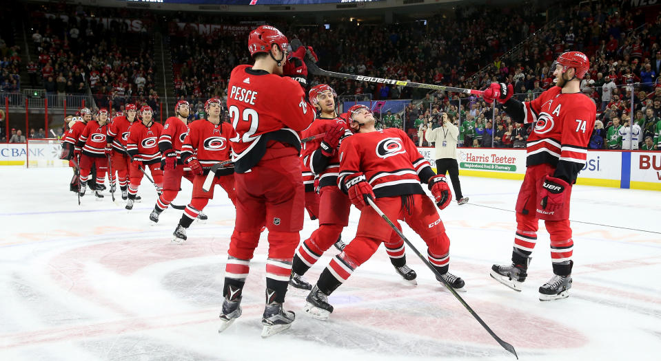 Members of the Carolina Hurricanes perform a limbo during the Storm Surge following a victory on Saturday night. (Photo by Gregg Forwerck/NHLI via Getty Images)