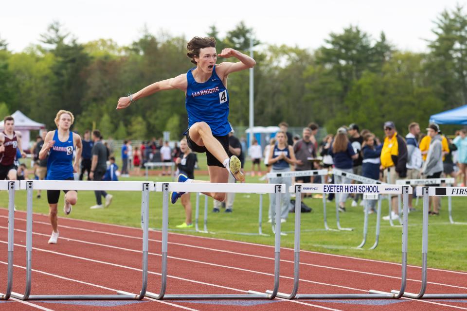 Winnacunnet's Oliver Duffy clears a hurdle in the 300-meter hurdles at Friday's Seacoast Track Championship meet at Exeter High School.