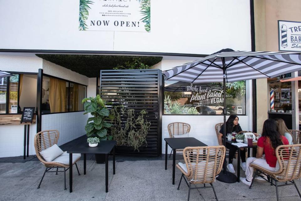 Sisters Melisa Alcaraz and Joana Alcaraz, right, eat lunch with friend Alicia Rubio at the Farmacy restaruant on 10th Street in Modesto, Calif., on Thursday, July 8, 2021.