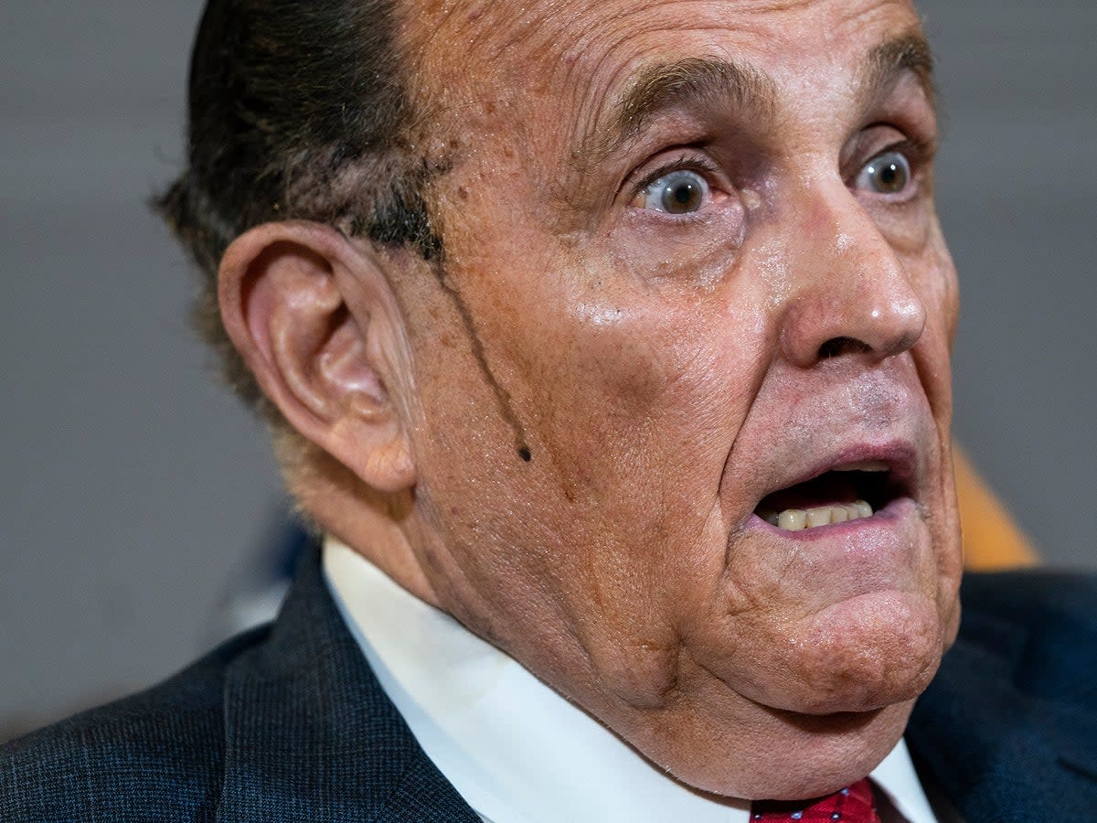 Hair dye runs down Giuliani’s cheek during a bizarre press conference in November 2020 (Getty)