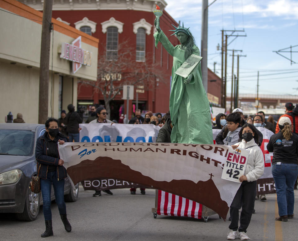 Residents and pro-migrant activists march in downtown El Paso, Texas, Saturday, Jan. 7, 2023. Several hundred marched through the streets of El Paso a day before President Joe Biden's first, politically-thorny visit to the southern border. (AP Photo/Andres Leighton)