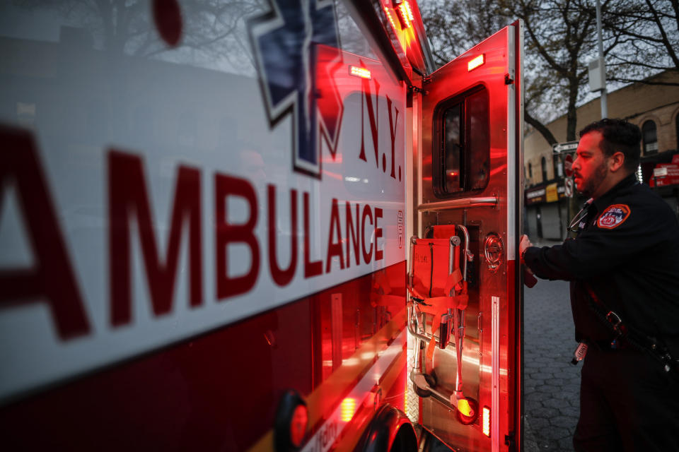 In this April 23, 2020, photo FDNY paramedic Alex Tull, who has recently recovered from COVID-19, prepares to begin his shift outside EMS station 26, the "Tinhouse", in the Bronx borough of New York. (AP Photo/John Minchillo)