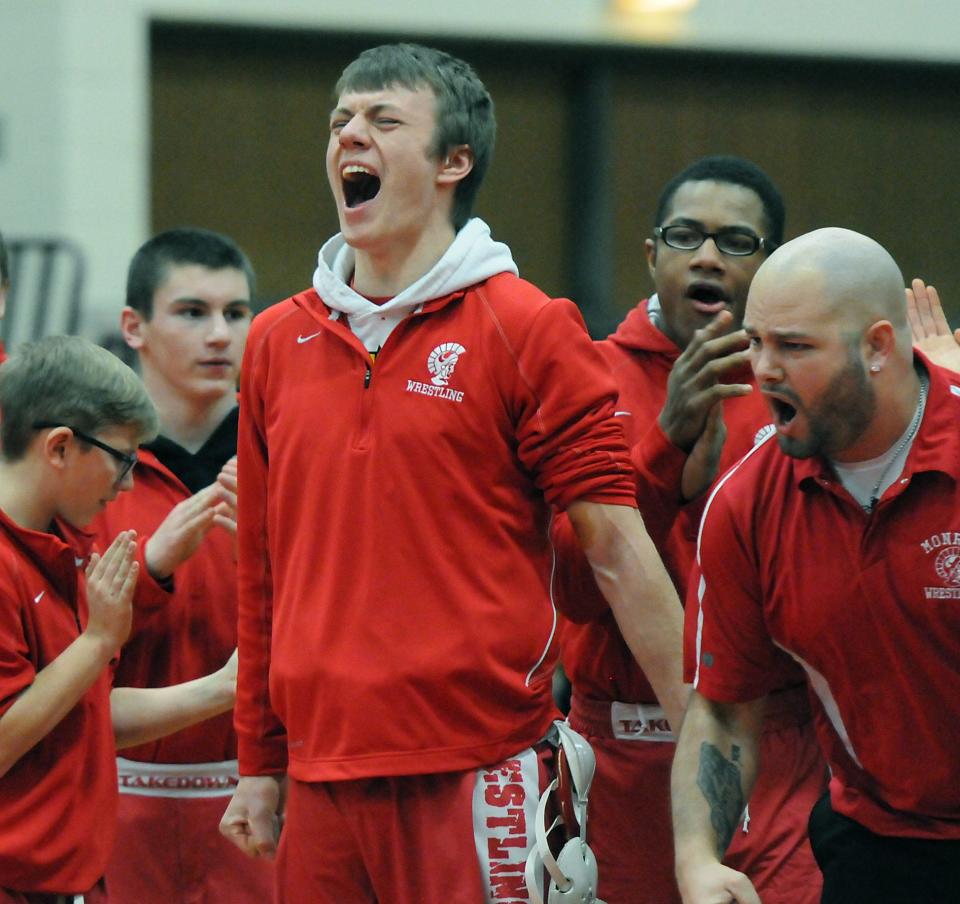 Tyler Hammack of Monroe reacts after teammate Arthur McCray won his match over Bedford's Ian Tyburski in the District semifinals February 11, 2015.