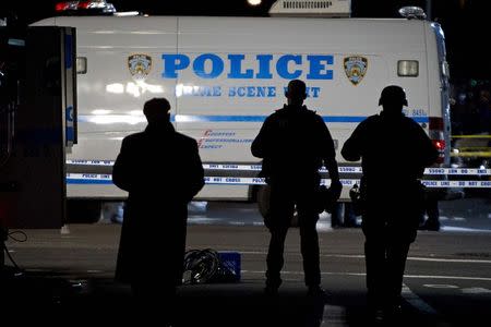 Police standby at the location where two NYPD officers were shot dead in Brooklyn, New York December 20, 2014. REUTERS/Carlo Allegri