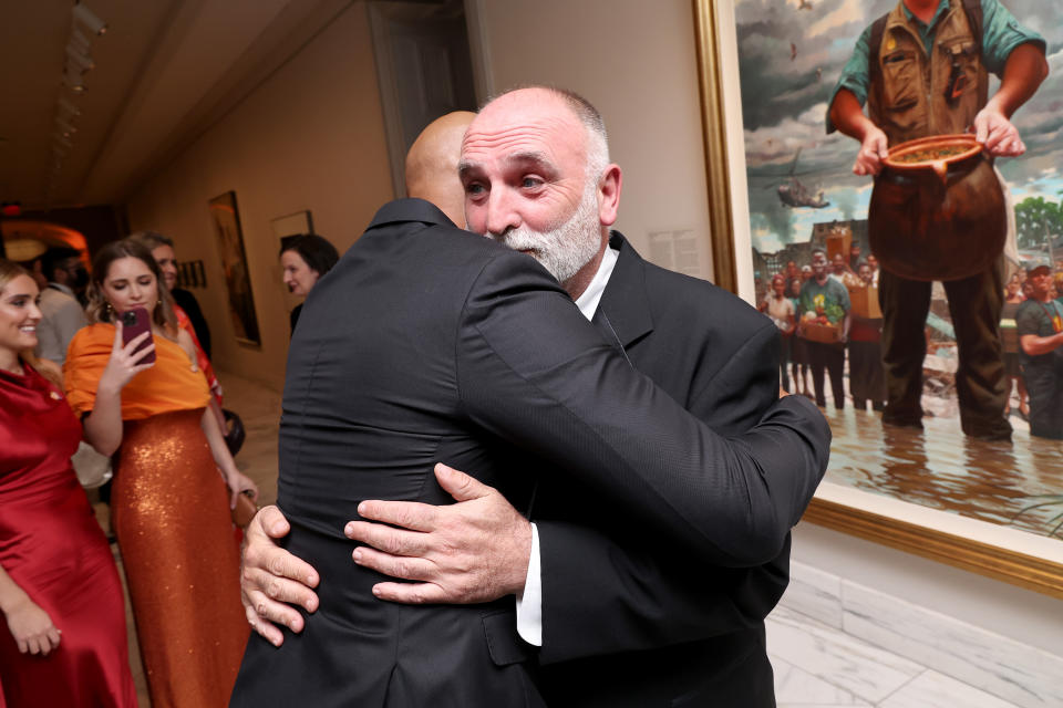 Kadir Nelson and José Andrés hug in front of Nelson’s portrait at the 2022 Portrait Of A Nation Gala.